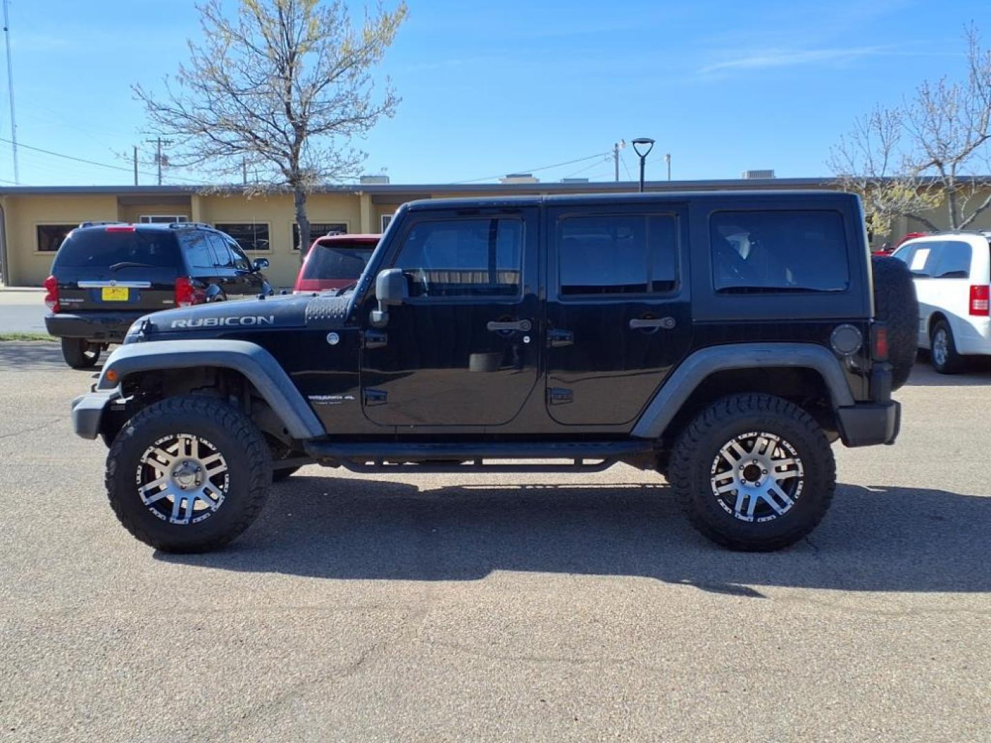 2011 Black Clear Coat Px8 Jeep Wrangler Unlimited Rubicon (1J4HA6H19BL) with an 3.8L 3.8L V6 202hp 237ft. lbs. Sequential Multiport Fuel Injection engine, 4-Speed Automatic transmission, located at 1401 N. Hobart, Pampa, TX, 79065, (806) 665-9872, 35.549953, -100.975098 - Photo#4